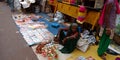 an indian village old woman selling devotional statue during diwali festival in India