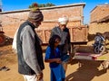 indian village people learning about laptop from school girl at open background in india January 2020