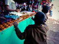 indian village poor kid looking for clothes during winter season at showroom in India dec 2019 Royalty Free Stock Photo