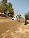 Indian  village road with car and a green tree Royalty Free Stock Photo