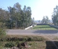 Indian village road with farmland and blue sky Royalty Free Stock Photo