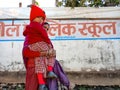 indian village school students coming with mother on street in India January 2020