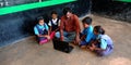 An indian village school teacher giving training to school kids