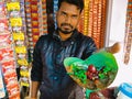 An indian village shopkeeper offering pan to the camera at panshop in india oct 2019