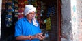 An indian village shopkeeper operating 4G mobile at shop