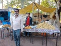 indian village shopkeeper selling traditional sweet at street shop in india January 2020