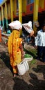 An Indian village woman carried vegetable sack on head in the rural market street Royalty Free Stock Photo