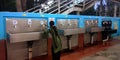 An indian village woman filling water bottle at indian railway station