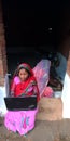 An indian village woman operating laptop computer system seating at corridor, indian farmers in technology mind