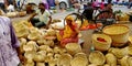 An indian village woman selling wooden basket at street