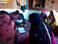 indian village women repaying loan installment at self help group center in India January 2020