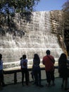 INDIAN WATERFALL IN PARK WITH PEOPLE