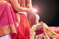 Indian wedding ceremony, bride and groom holding fire in hands on black background with copy space