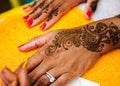 Indian wedding guest having mehndi applied. Traditional henna art. Royalty Free Stock Photo