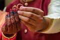 Couple Holding In Their Fingers Two golden Wedding Rings