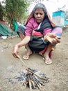 Indian winter wooding fire in village with old lady Royalty Free Stock Photo