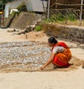 Indian woman apportion fish. Palolem beach.