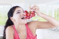 Indian woman with bunch of grapes Royalty Free Stock Photo