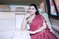 Indian woman in car with container background