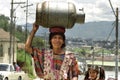 Indian woman carries gas cylinder on head