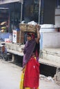 Indian woman carrying basket on her head, Bundi, India