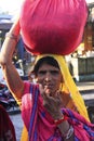 Indian woman carrying bundle on her head, Bundi, India