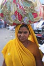 Indian woman carrying bundle on her head, Bundi, India