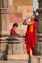 Indian woman with a child dringking water at Quwwat-Ul-Islam mos Royalty Free Stock Photo