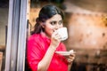 Indian woman with coffee mug