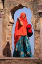 Indian woman in colorful sari standing in the arch, Ranthambore