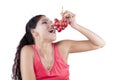 Indian woman eating red grapes Royalty Free Stock Photo