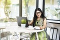 Indian woman with eyeglass using a laptop Royalty Free Stock Photo