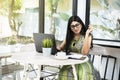 Indian woman with eyeglass using a laptop Royalty Free Stock Photo