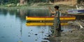 Indian woman feeding birds on the banks of Yamuna River