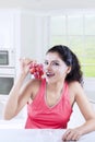 Indian woman with fresh grapes at home Royalty Free Stock Photo