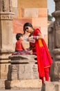 Indian woman giving water to her child at Quwwat-Ul-Islam mosque