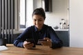 Indian woman hold plastic card connect with e-bank by cell