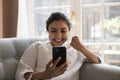 Indian woman holds cellphone got fantastic news feels overjoyed Royalty Free Stock Photo