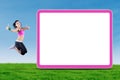 Indian woman jumping near billboard at field Royalty Free Stock Photo