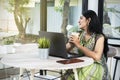 Indian woman with laptop on the table holding coffee Royalty Free Stock Photo