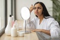 Indian Woman Looking At Mirror And Checking Pimple On Forehead Royalty Free Stock Photo