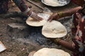 Indian woman making Indian flat bread tandoori roti chapati with hand