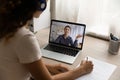 Indian woman participate in videoconference screen view over female shoulder