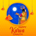 Indian woman performing Hindu married festival Karwa Cahuth looking moon through shieve