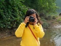 Indian woman photographer using digital camera to take travel photograph. Tourist girl capturing the moment