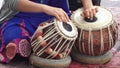 Indian woman playing Indian music on Tabla Punjabi drums