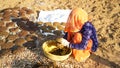 Indian woman preparing cow dung and making dung cakes for sacred festivals. Religious culture to make cow dung cakes on Holi Royalty Free Stock Photo