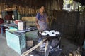 Indian woman preparing dosa at a kitchen, Auroville