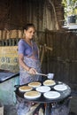 Indian woman preparing dosa at a kitchen, Auroville