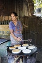 Indian woman preparing dosa at a kitchen, Auroville